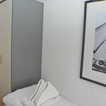 Bedroom with wardrobe and picture on the wall.