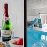 Sekt und Obst auf Tisch. Indoor-Pool mit Rutsche und Terrasse.