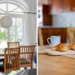 Esszimmer mit Holztisch, Stühlen und Fenster. Kaffee und Croissants auf der Theke.