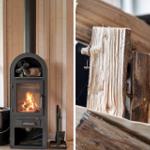 Kaminofen mit brennendem Holz und Stapel Brennholz in rustikaler Umgebung.