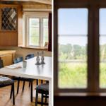 Esszimmer mit Tisch, Stühlen und Blick auf grüne Landschaft.