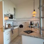 Kitchen with worktop, sink, microwave, and coffee machine.