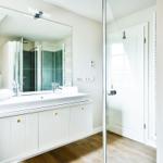 Bathroom with sink, mirror, and shower
