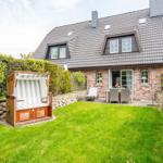 House with garden, beach chair, and terrace. Wooden terrace with garden furniture.