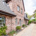 Brick house with garden gate and paved path
