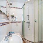 Bathroom with shower, sink, and heater