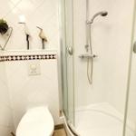 Bathroom with shower, toilet, and wall decor