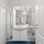Bathroom with sink, mirror, and shower.