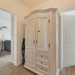 Bedroom with balcony view. Hallway with wardrobe and view into living room.