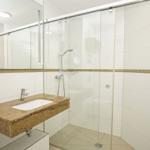 Bathroom with shower, sink, and mirror