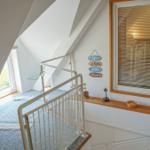 Staircase with window and sign on the wall