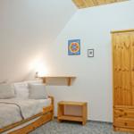 Bedroom with wooden bed, wardrobe, and wall art.