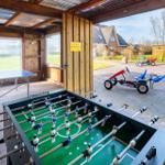Fußballtisch und Tischtennis im Freien mit Kinderfahrrädern auf dem Hof