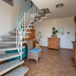 Staircase with spiral stairs and wooden furniture in the hallway.