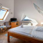 Bedroom with skylight, bed, and small table