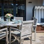 Outdoor area with set dining table and beach chair.