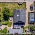 House with garden, terrace, and pool. A car is parked on the yard.