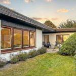 House with garden and terrace. Windows show inside.
