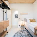 Schlafzimmer mit Bett, Kleiderschrank und Wandbild