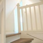 Dachgeschosszimmer mit weißem Schrank und Tür unter Dachschrägen.