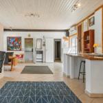 Living area with dining space, bar, and artwork on the walls.