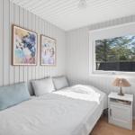 Bedroom with bed, window, and nightstand