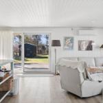 Living room with sofa, blanket, and view of the terrace