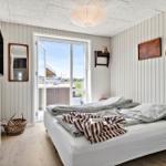 Bedroom with bed, window, and wall decor.