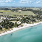 Aerial view of a beach with holiday homes and camping site