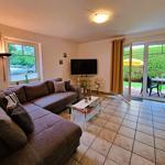 Living room with sofa, TV, and terrace