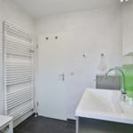 Bathroom with sink, heater, and door.