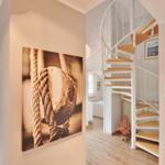 House with spiral staircase, wall picture, and view of balcony