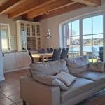Living area with sofa, fireplace, and view of the lake.