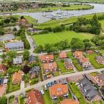 View of residential area with river, marina, and sports field