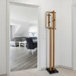 Entryway with coat stand and view into living and bedroom.