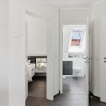 Bedroom and bathroom with skylight and modern furnishings.