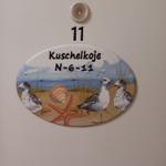 Unit 11 with beach motif: seagulls, shell, and starfish on oval plaque.