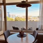 Round dining room with view of the city and the sea.