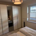 Bedroom with wardrobe, bed, and window with blinds.
