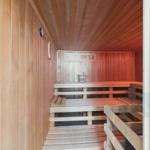 Wooden sauna with benches and bucket