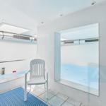 Indoor pool with seating area and shower