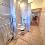 Shower with seat, shower curtain, and heater on wall