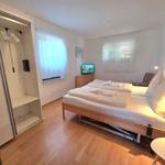 Bedroom with double bed, wardrobe, and TV.