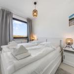 Bedroom with double bed, window, and wall picture.