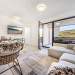 Living area with sofa, TV, and view of the dunes.