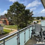 Terrace with chairs and view of green areas and houses