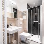 Bathroom with shower, sink, and toilet. Modern equipment.