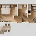 Ein Schlafzimmer mit Bett, Schrank und Sitzgelegenheit. Küche, Bad und Terrasse mit Tisch und Stühlen.