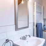 Sink with mirror and towel rack on the wall