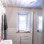 Bathroom with shower, sink, and window